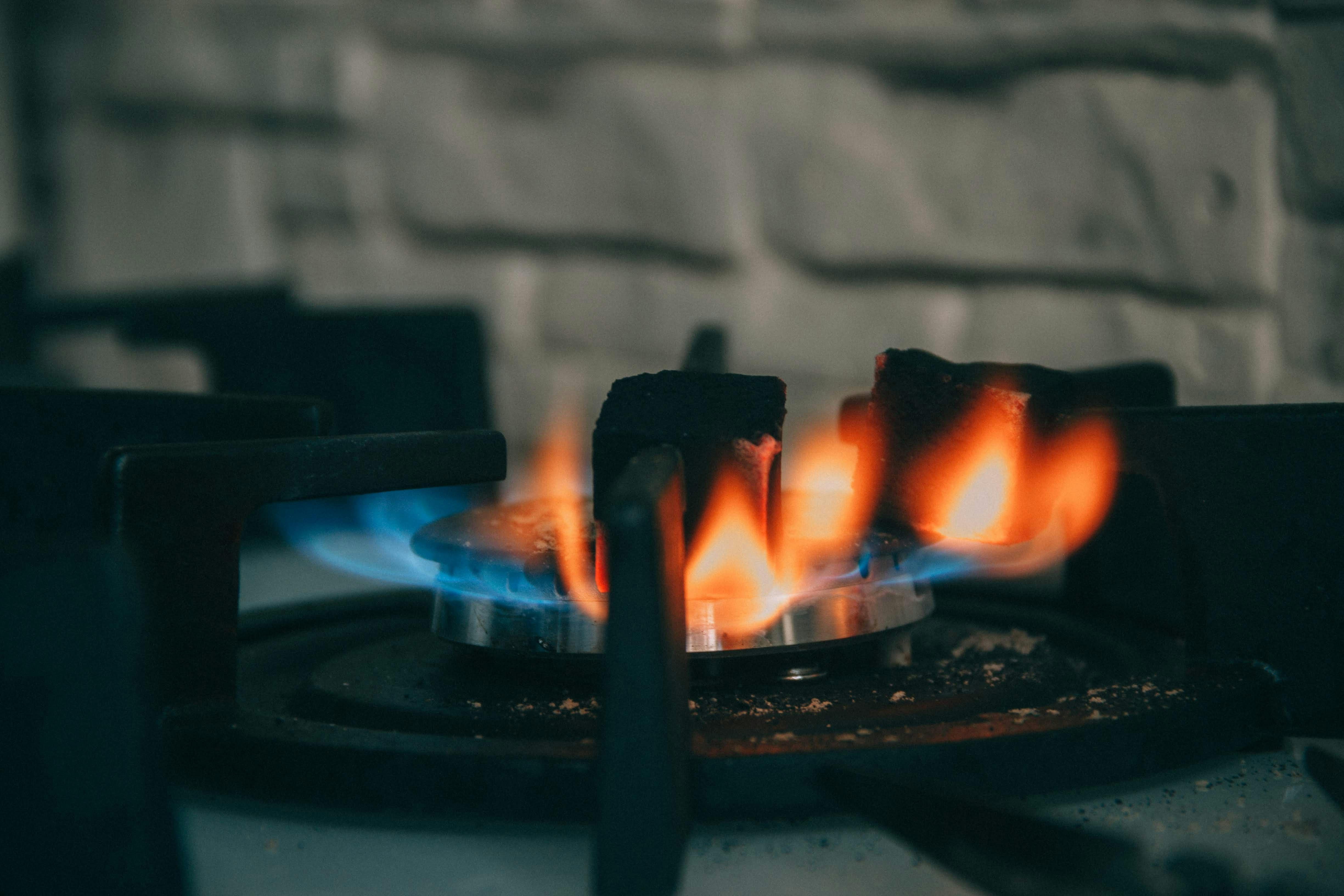 selective focus photography of stove with fire